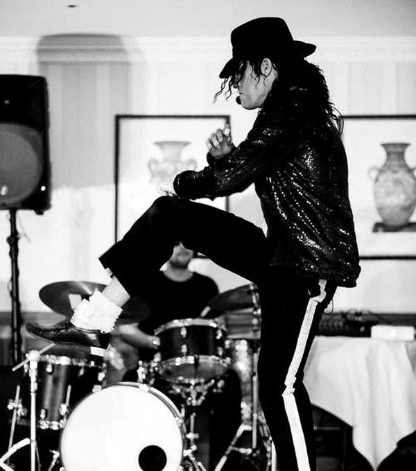 Mid-show at a private function, live band behind